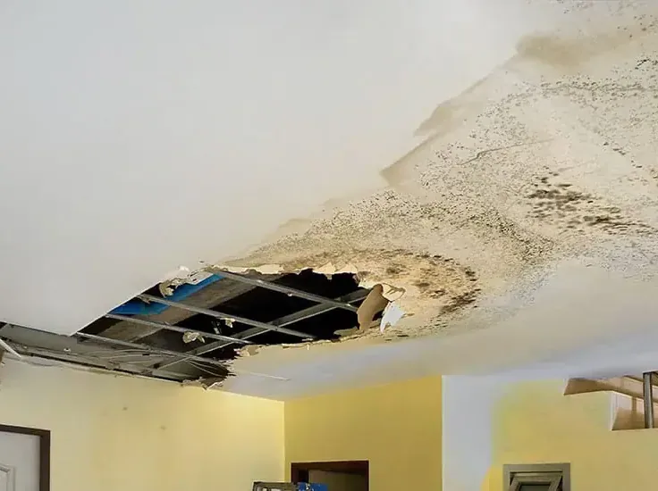 A water-stained ceiling sagging from a leak above