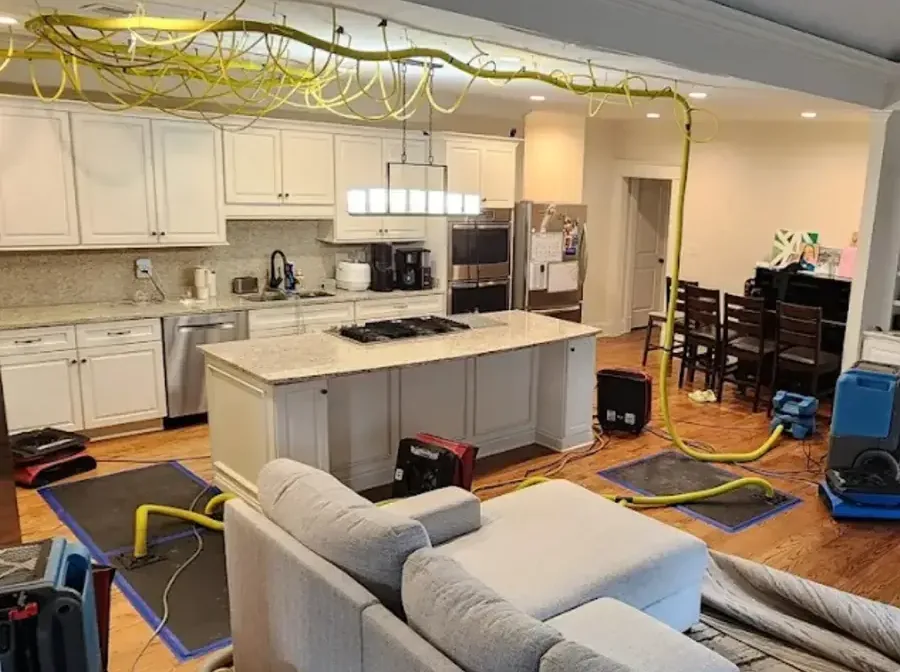 Air movers, dehumidifiers and floor drying mats running in a home